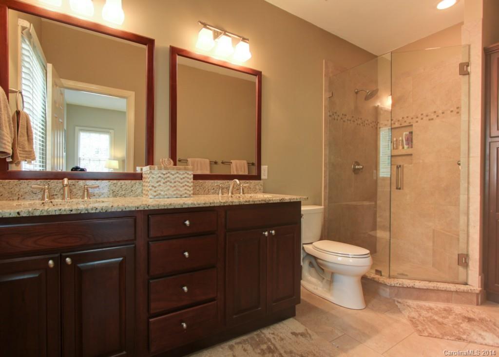 2406 Sharon Road Charlotte, NC 28211 - Photo 8 of 15 a bathroom with a granite countertop sink toilet a mirror and shower