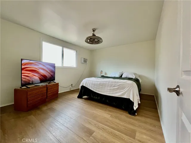 a bedroom with bed couch and window