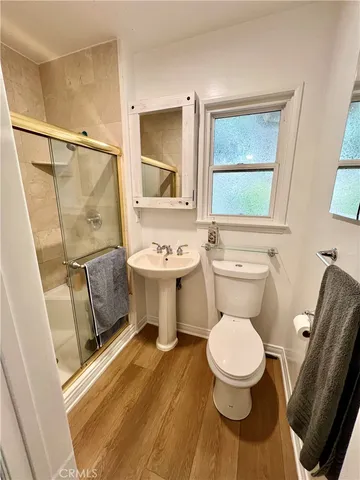 a white toilet sitting next to a bathroom sink
