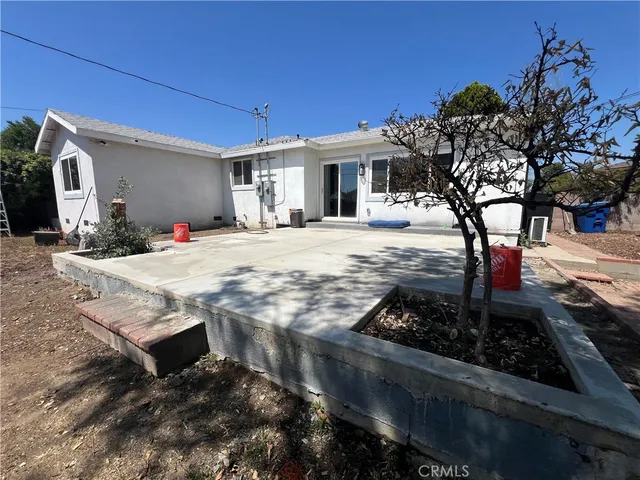 a view of a house with backyard porch and sitting area