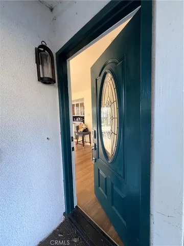 a view of a entryway door with wooden floor
