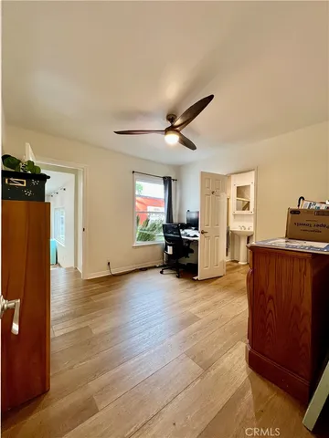 a view of a livingroom with a furniture hardwood floor and a ceiling fan