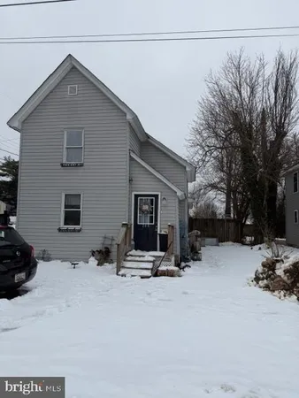 a view of a house with a snow in the road