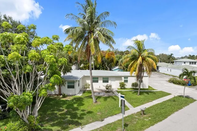 a view of a house with swimming pool and sitting area