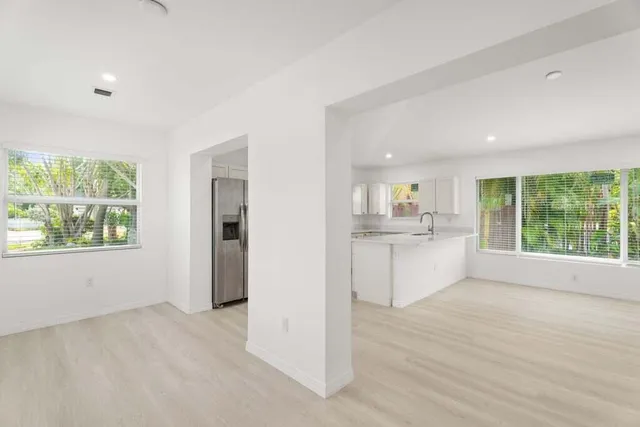 a view of a kitchen with window and wooden floor