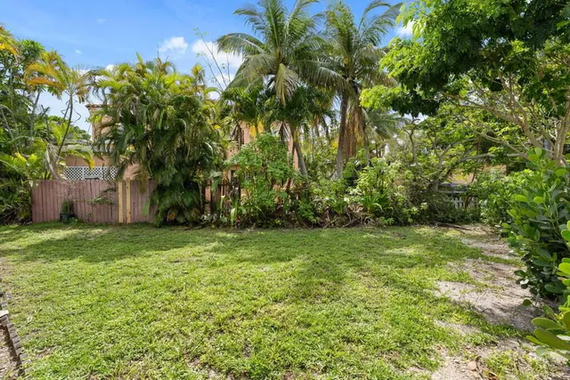 a view of a swimming pool with a table and chairs under an umbrella