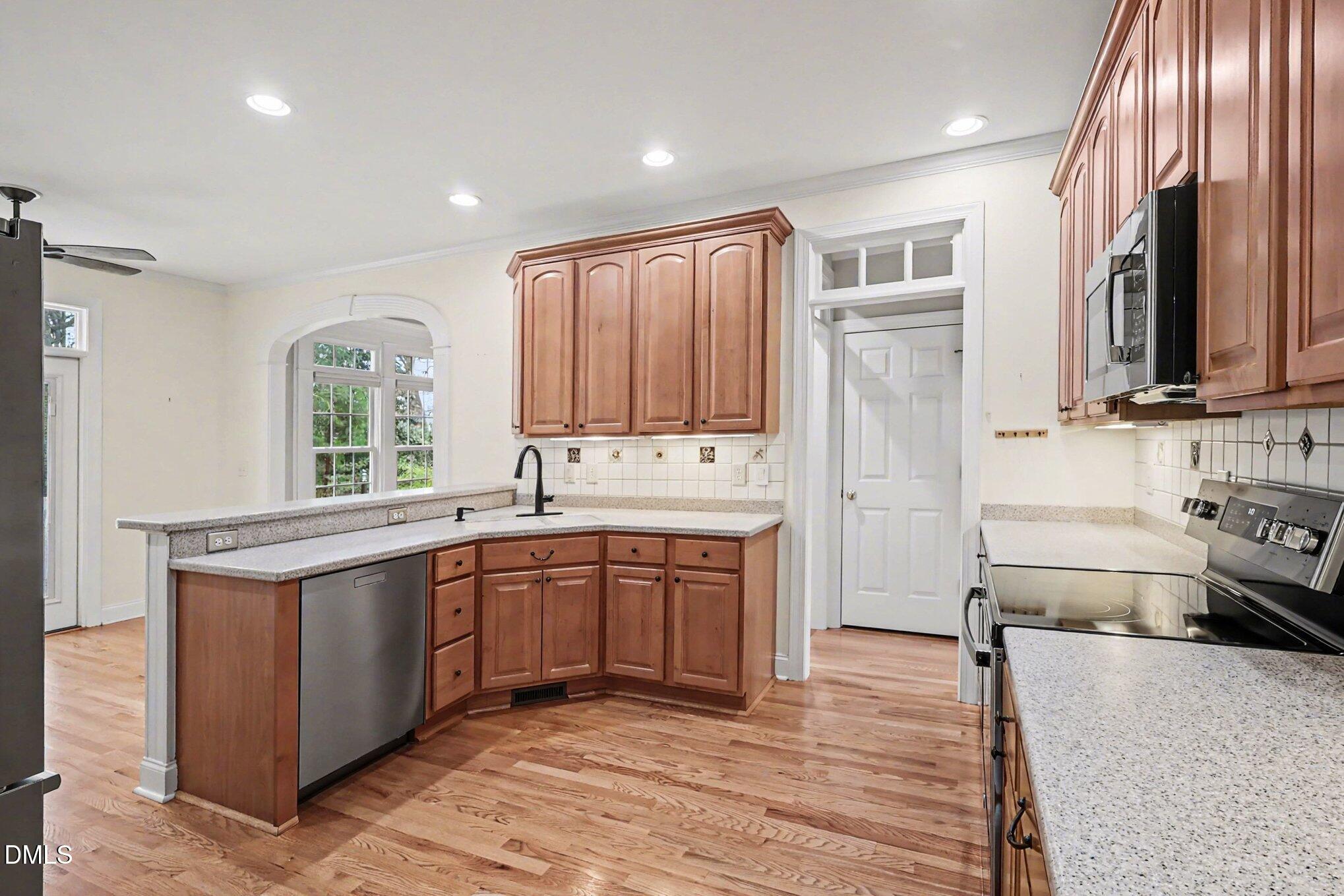 1108 Neuse Ridge Drive Clayton, NC 27527 - Photo 14 of 52 a large kitchen with stainless steel appliances granite countertop a stove a sink dishwasher and a refrigerator