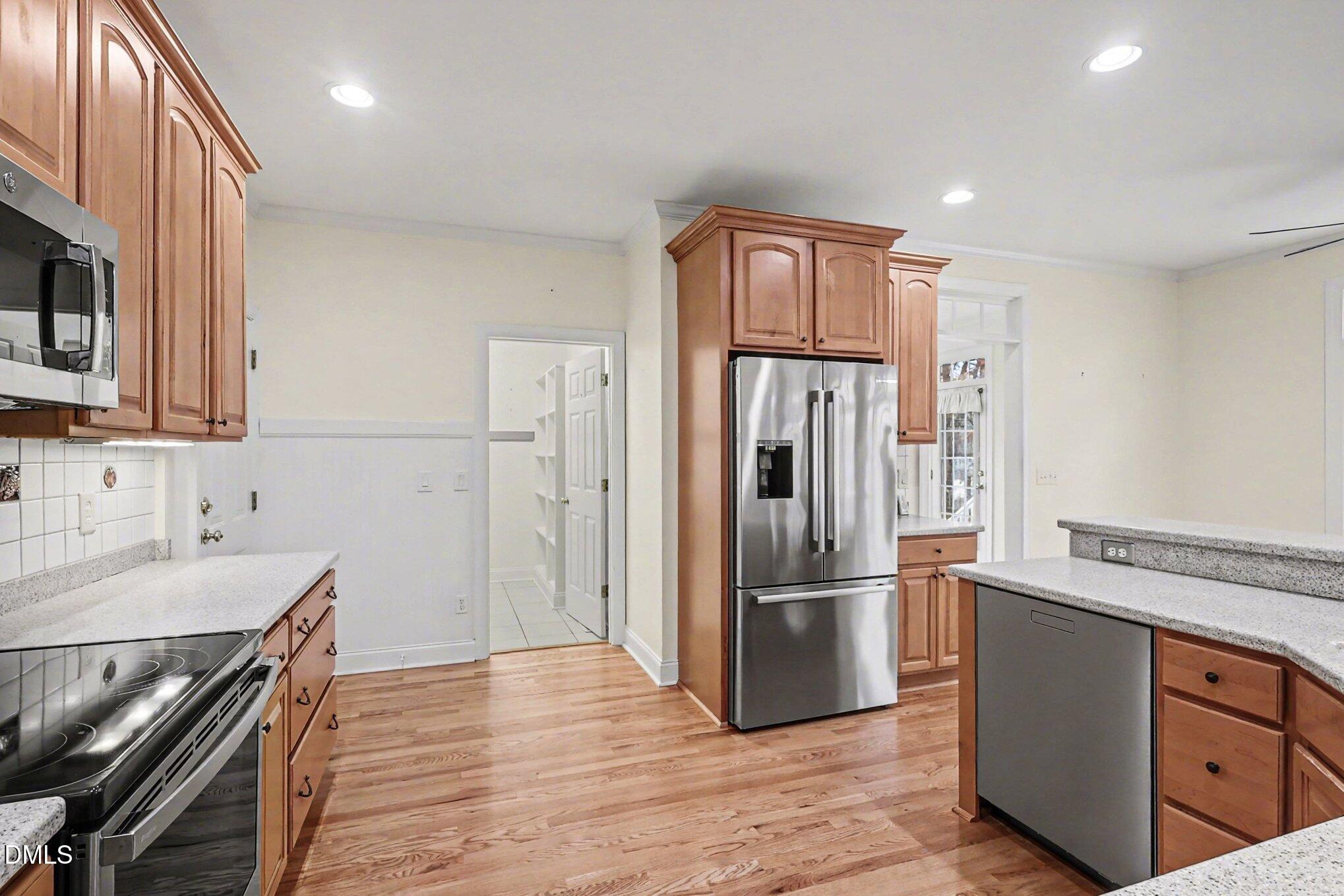 1108 Neuse Ridge Drive Clayton, NC 27527 - Photo 15 of 52 a kitchen with stainless steel appliances granite countertop a refrigerator and a stove top oven