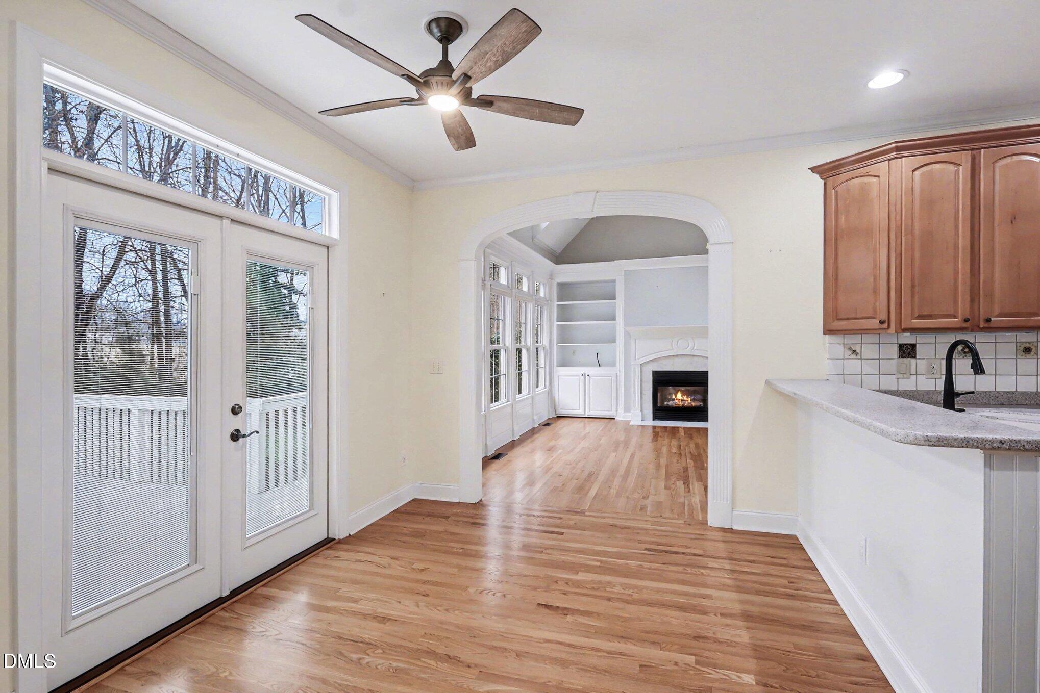 1108 Neuse Ridge Drive Clayton, NC 27527 - Photo 18 of 52 a view of a livingroom with wooden floor and a kitchen space