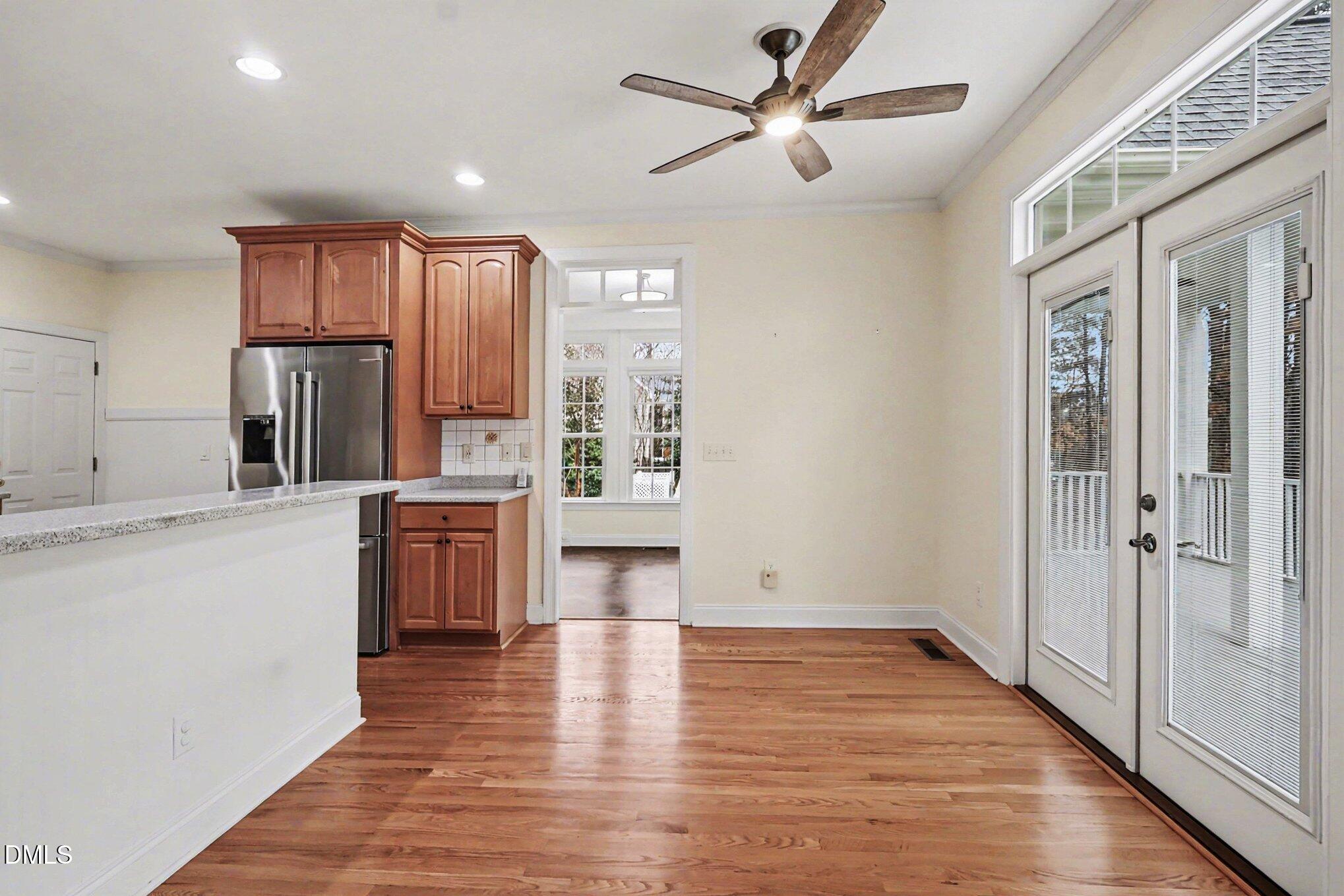 1108 Neuse Ridge Drive Clayton, NC 27527 - Photo 19 of 52 a kitchen with kitchen island white cabinets and stainless steel appliances