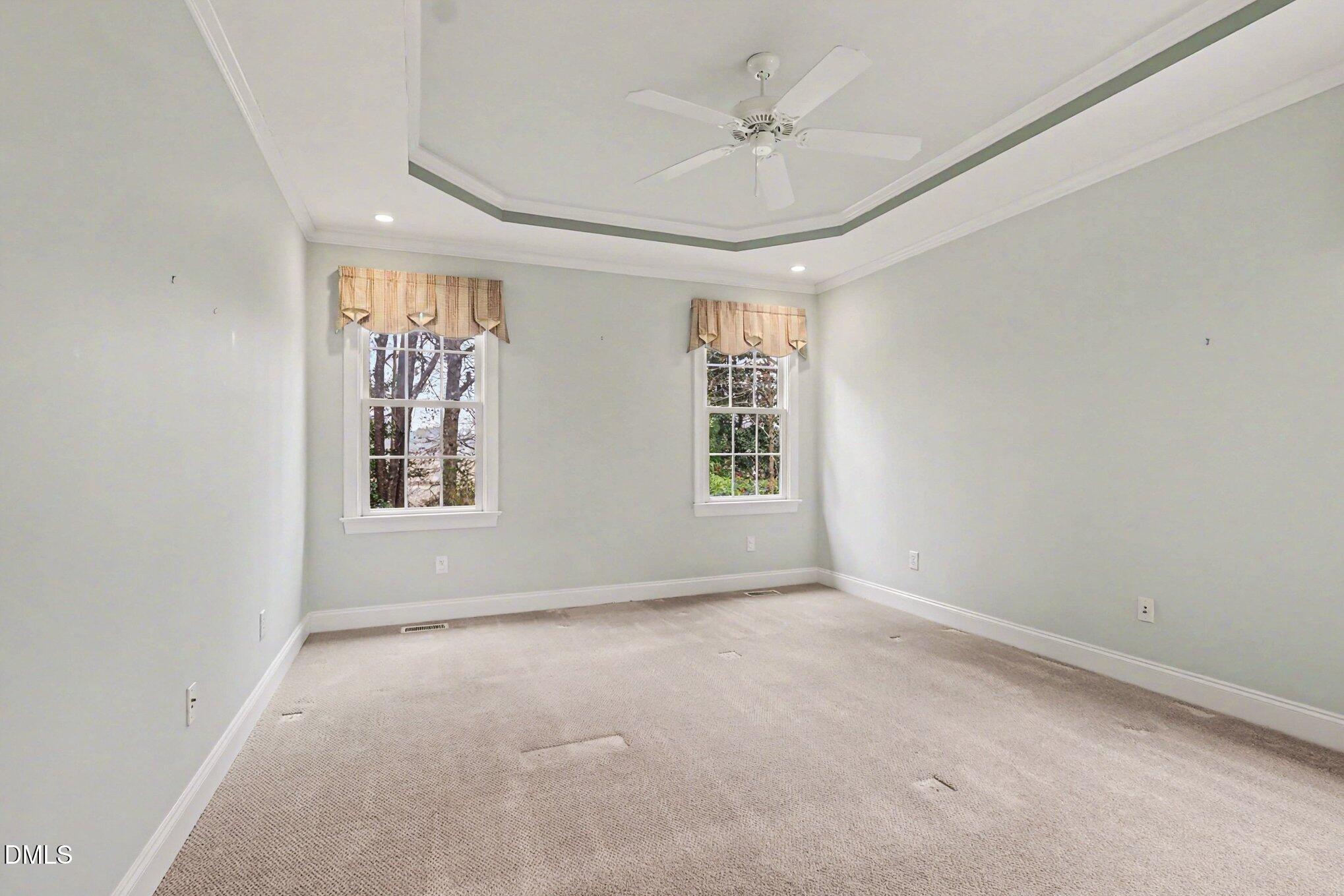 1108 Neuse Ridge Drive Clayton, NC 27527 - Photo 22 of 52 an empty room with windows and fan