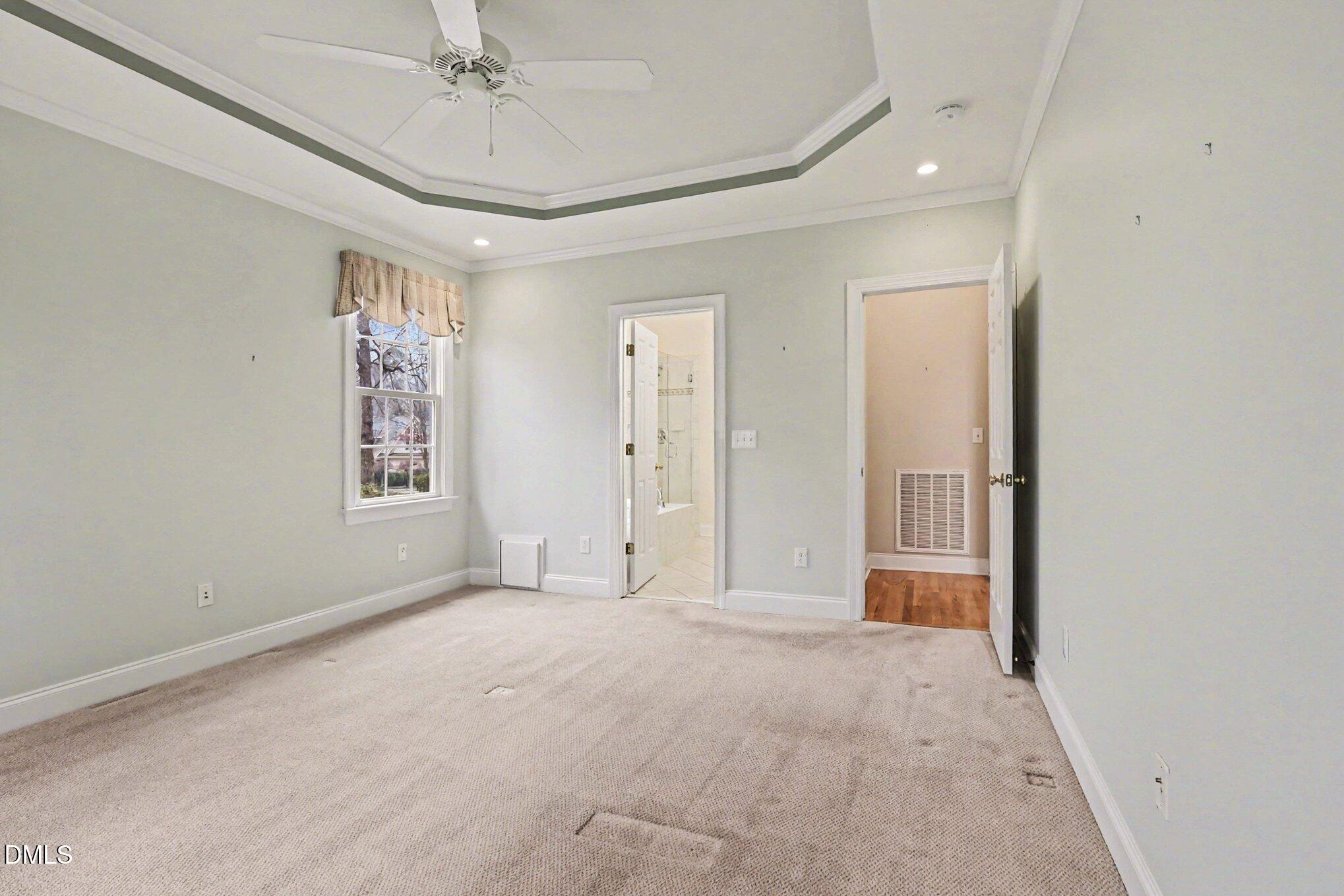 1108 Neuse Ridge Drive Clayton, NC 27527 - Photo 25 of 52 en empty room with windows and chandelier fan