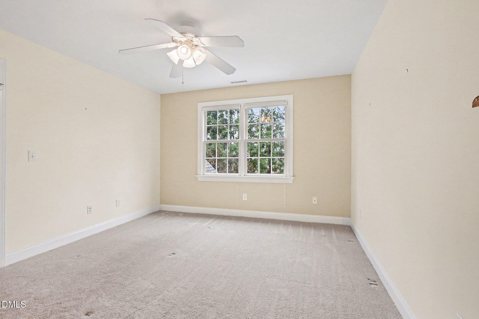 1108 Neuse Ridge Drive Clayton, NC 27527 - Photo 31 of 52 an empty room with a window and a fan