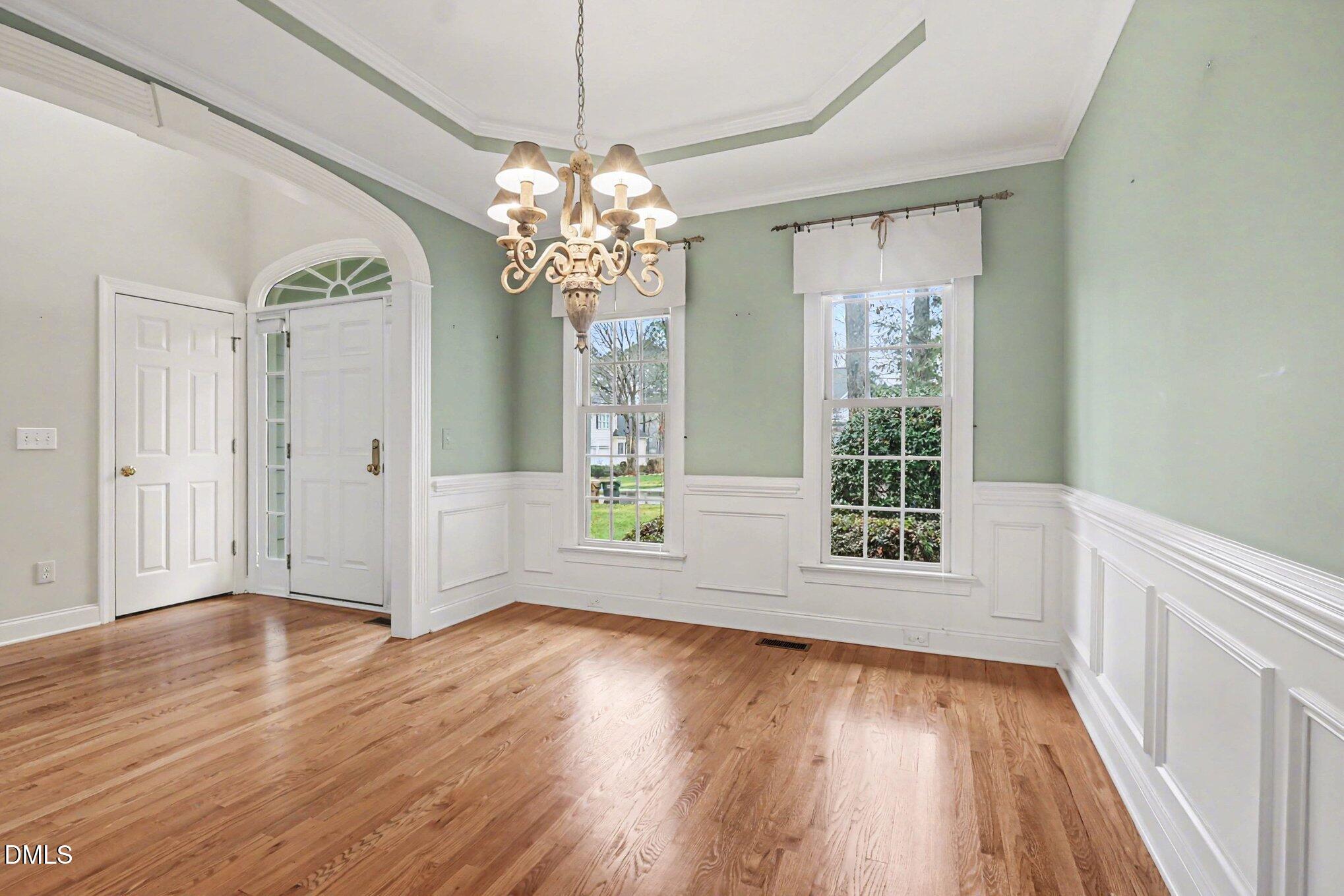 1108 Neuse Ridge Drive Clayton, NC 27527 - Photo 7 of 52 a view of an empty room with wooden floor and a window