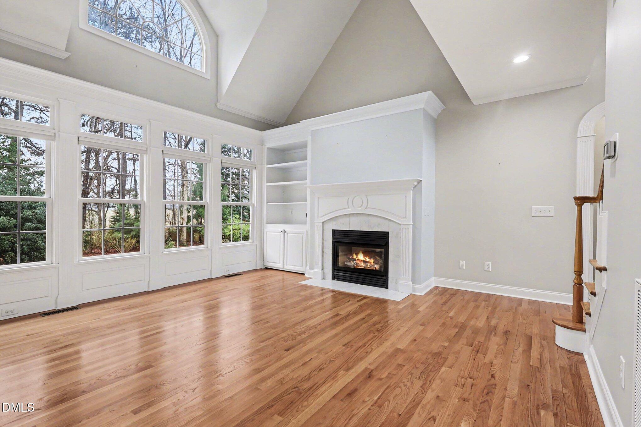 1108 Neuse Ridge Drive Clayton, NC 27527 - Photo 8 of 52 a view of empty room with wooden floor and fireplace