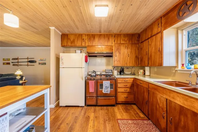 a kitchen with stainless steel appliances a sink and cabinets