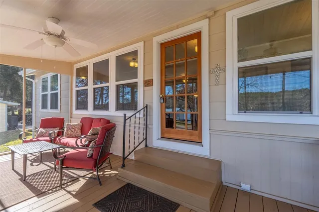a living room with furniture a front door and wooden floor