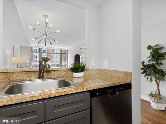 1150 K Street Northwest, Unit 709 Washington, DC 20005 - Photo 15 of 25 a kitchen with a granite countertop sink a counter top space and cabinets