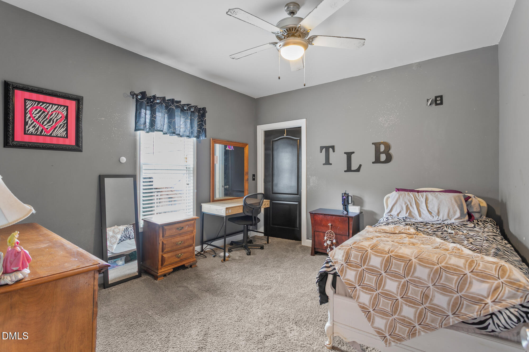 3163 Saul Loop Road Elon, NC 27244 - Photo 16 of 44 a bedroom with a bed and a chandelier