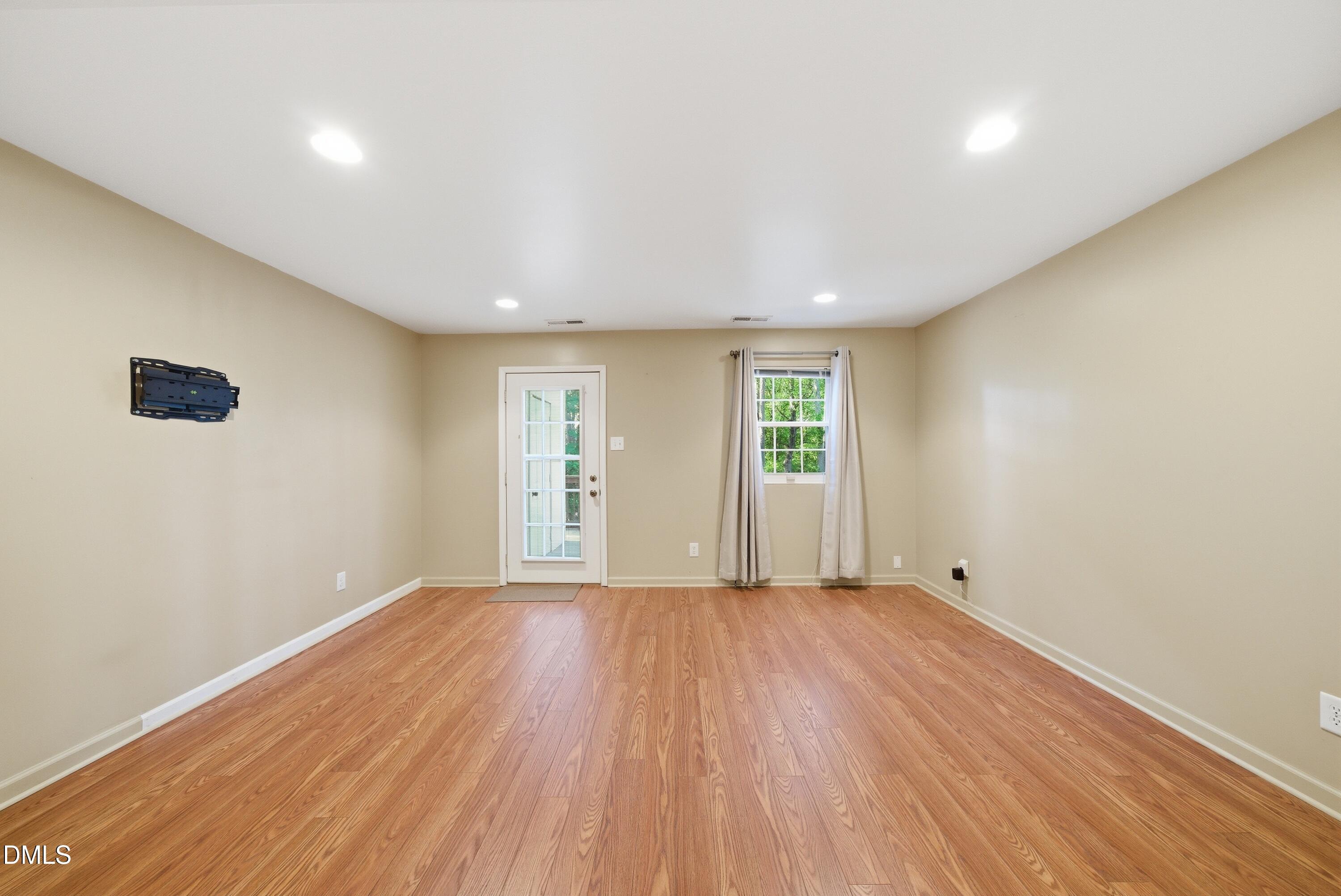 6355 New Market Way Raleigh, NC 27615 - Photo 16 of 30 wooden floor in an empty room with a window