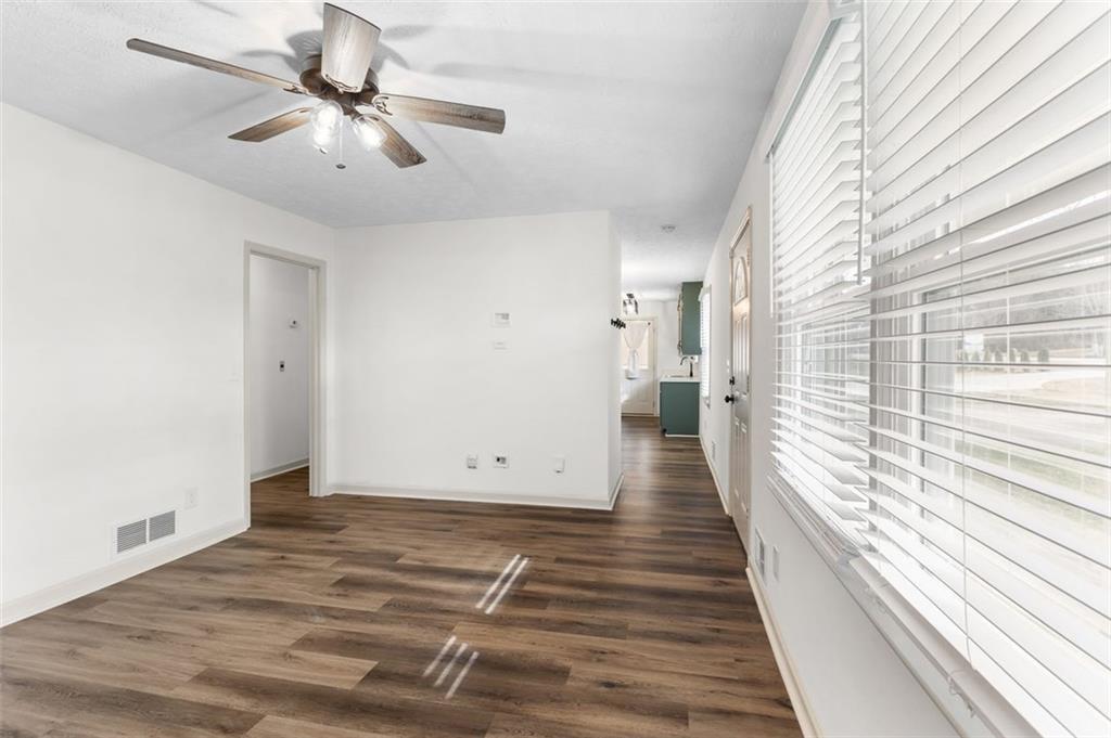 2720 North Bogan Road Northeast Buford, GA 30519 - Photo 12 of 29 a view of a room with wooden floor and ceiling fan