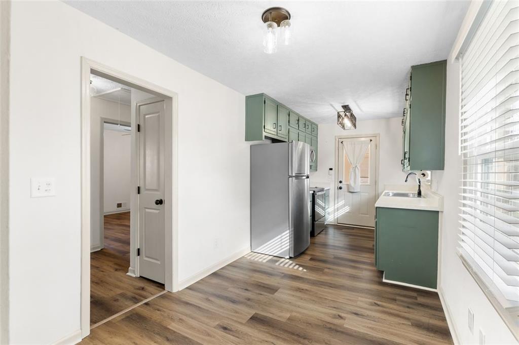 2720 North Bogan Road Northeast Buford, GA 30519 - Photo 13 of 29 a view of living room and kitchen with wooden floor