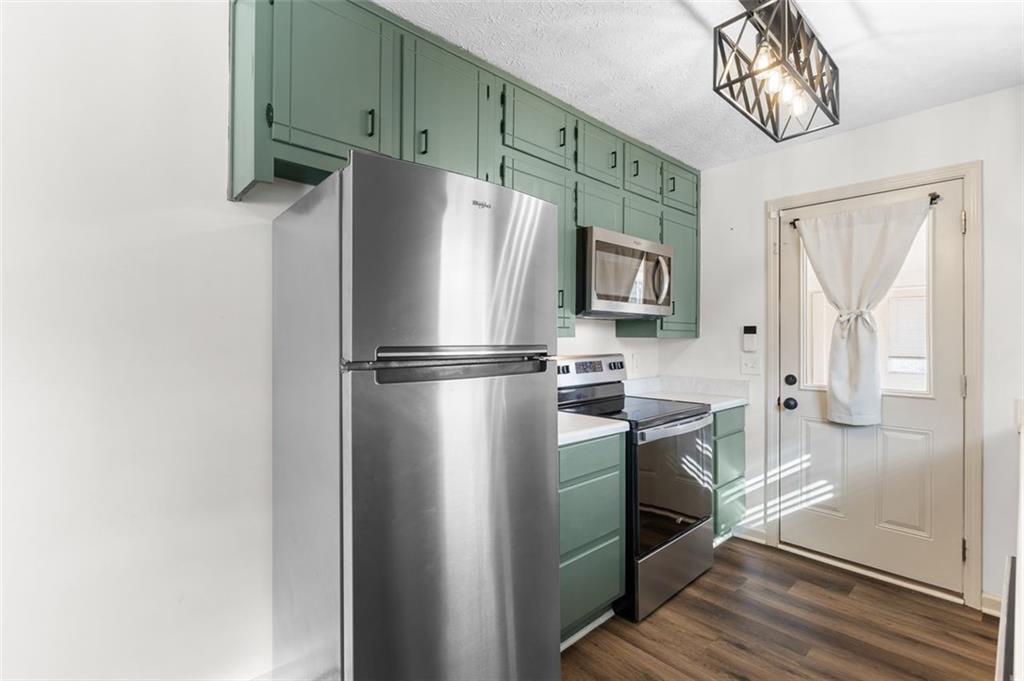 2720 North Bogan Road Northeast Buford, GA 30519 - Photo 14 of 29 a kitchen with stainless steel appliances granite countertop a refrigerator a stove and a sink