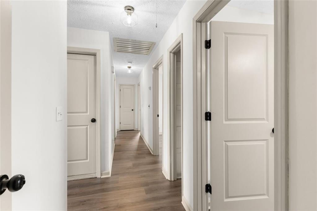 2720 North Bogan Road Northeast Buford, GA 30519 - Photo 16 of 29 a view of a hallway with wooden floor