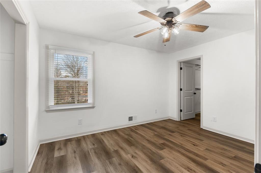 2720 North Bogan Road Northeast Buford, GA 30519 - Photo 17 of 29 wooden floor in an empty room with a window