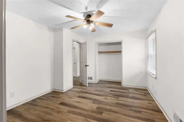 a view of an empty room with wooden floor