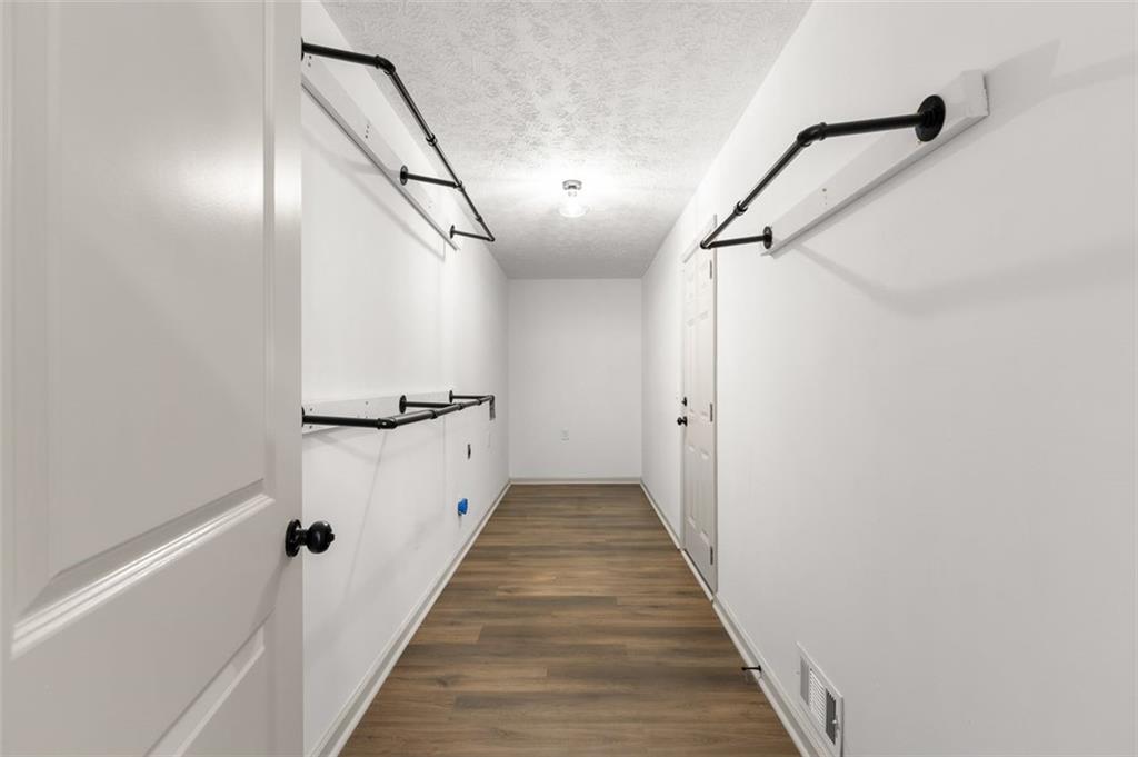 2720 North Bogan Road Northeast Buford, GA 30519 - Photo 19 of 29 a view of a hallway with wooden floor and staircase