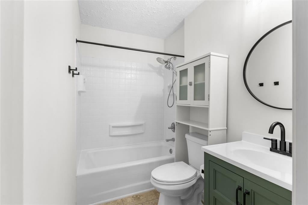 2720 North Bogan Road Northeast Buford, GA 30519 - Photo 20 of 29 a bathroom with a sink toilet and a mirror
