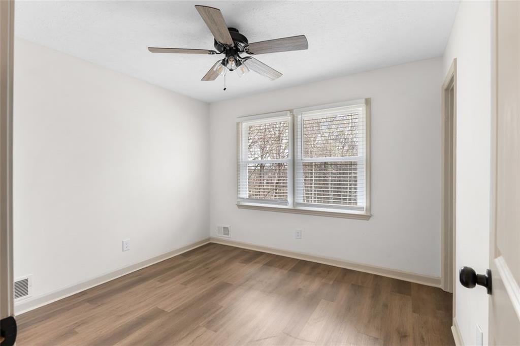 2720 North Bogan Road Northeast Buford, GA 30519 - Photo 21 of 29 a view of a big room with wooden floor and windows