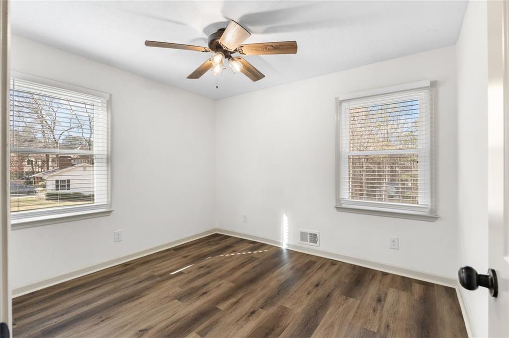 2720 North Bogan Road Northeast Buford, GA 30519 - Photo 22 of 29 a view of an empty room with wooden floor and a window