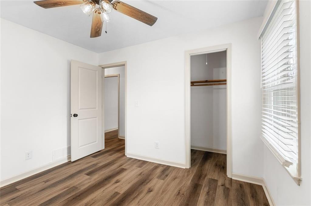 2720 North Bogan Road Northeast Buford, GA 30519 - Photo 23 of 29 a view of an empty room with a window and wooden floor