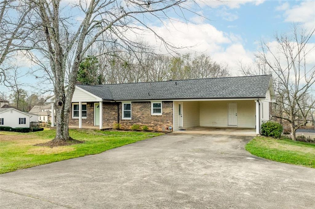 2720 North Bogan Road Northeast Buford, GA 30519 - Photo 4 of 29 a front view of a house with a yard and garage