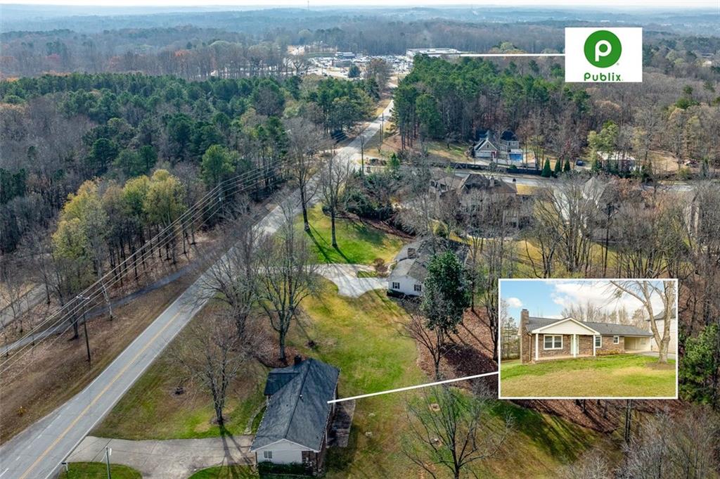 2720 North Bogan Road Northeast Buford, GA 30519 - Photo 8 of 29 a view of a house with a yard and a wooden bench