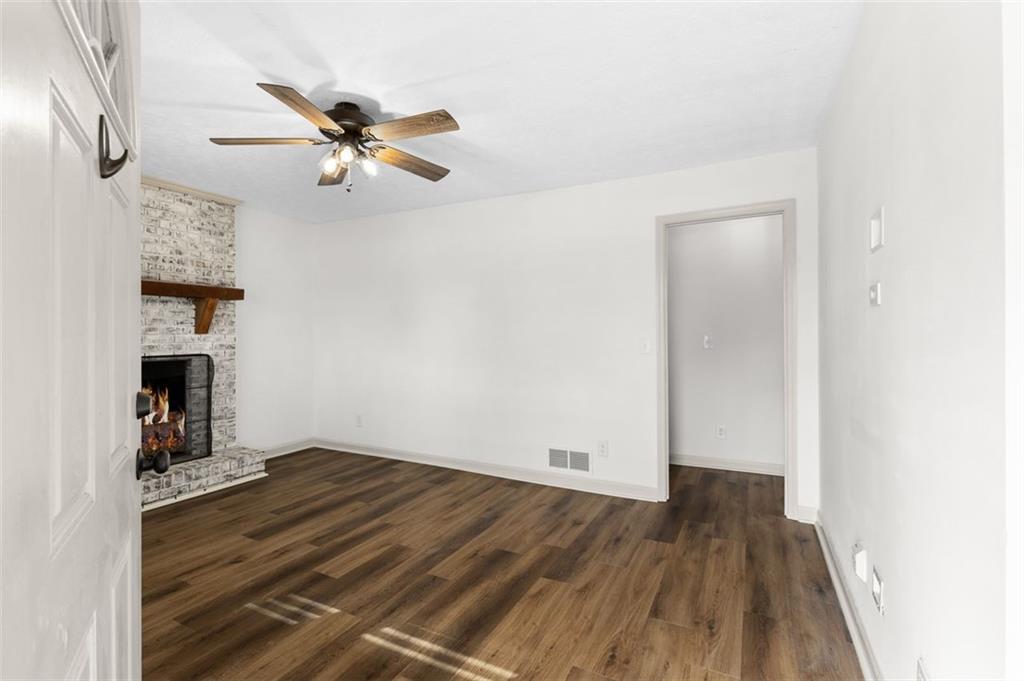 2720 North Bogan Road Northeast Buford, GA 30519 - Photo 10 of 29 an empty room with wooden floor closet and windows