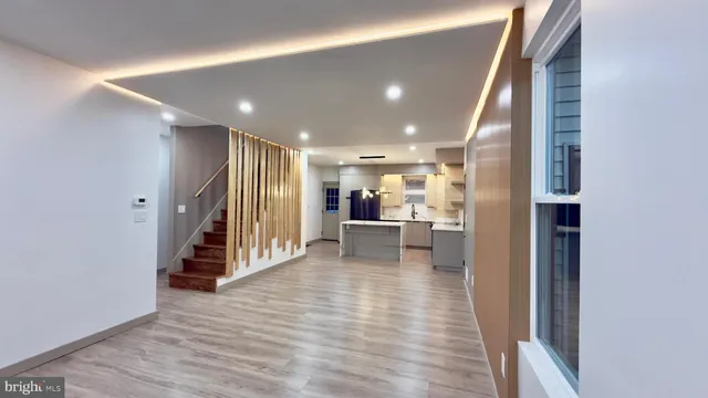 a large white kitchen with kitchen island a sink a stove a refrigerator and a cabinets