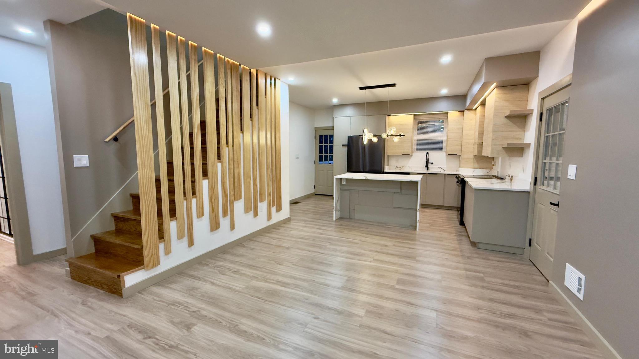 1011 Elnore Avenue Temple, PA 19560 - Photo 18 of 61 a view of a kitchen with kitchen island stainless steel appliances counter space and wooden floor