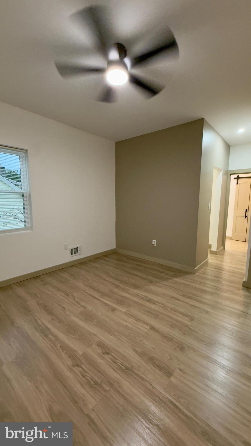 1011 Elnore Avenue Temple, PA 19560 - Photo 38 of 61 an empty room with wooden floor and windows
