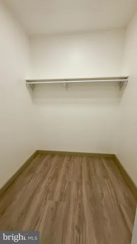 a bathroom with a toilet and a mirror