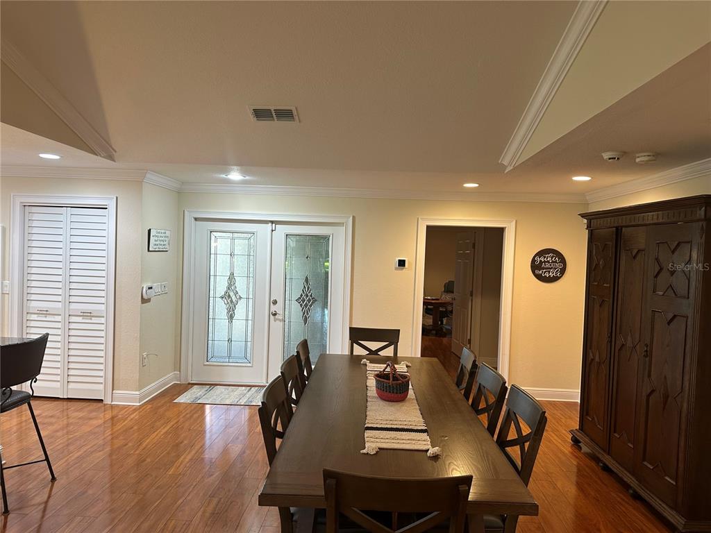 104 Woden Way Winter Haven, FL 33884 - Photo 15 of 48 a view of a dining room with furniture window and wooden floor