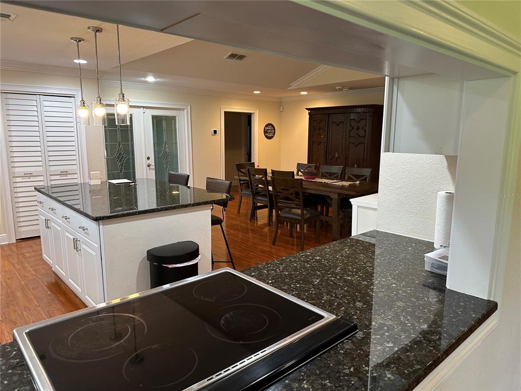 104 Woden Way Winter Haven, FL 33884 - Photo 19 of 48 a kitchen with kitchen island sink stove and cabinets