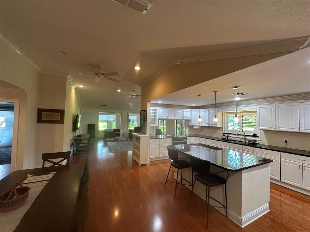 104 Woden Way Winter Haven, FL 33884 - Photo 20 of 48 a large kitchen with lots of counter space a sink and chairs