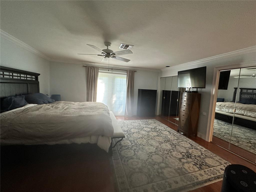 104 Woden Way Winter Haven, FL 33884 - Photo 22 of 48 a bedroom with a bed and a television in it