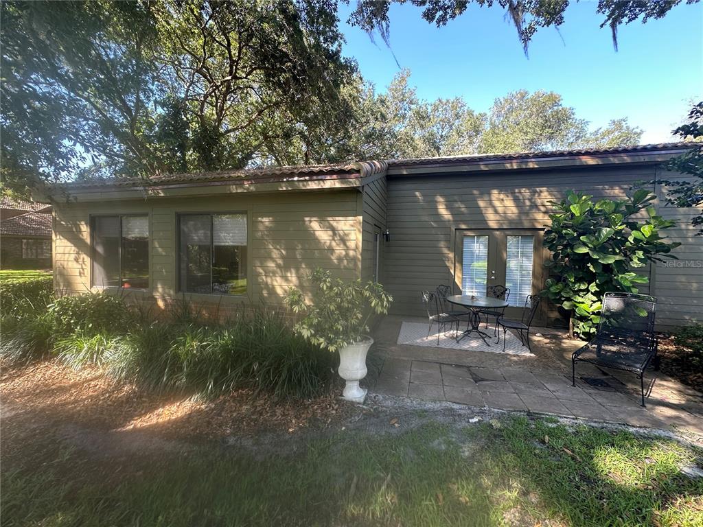 104 Woden Way Winter Haven, FL 33884 - Photo 31 of 48 a view of a wooden house with a yard