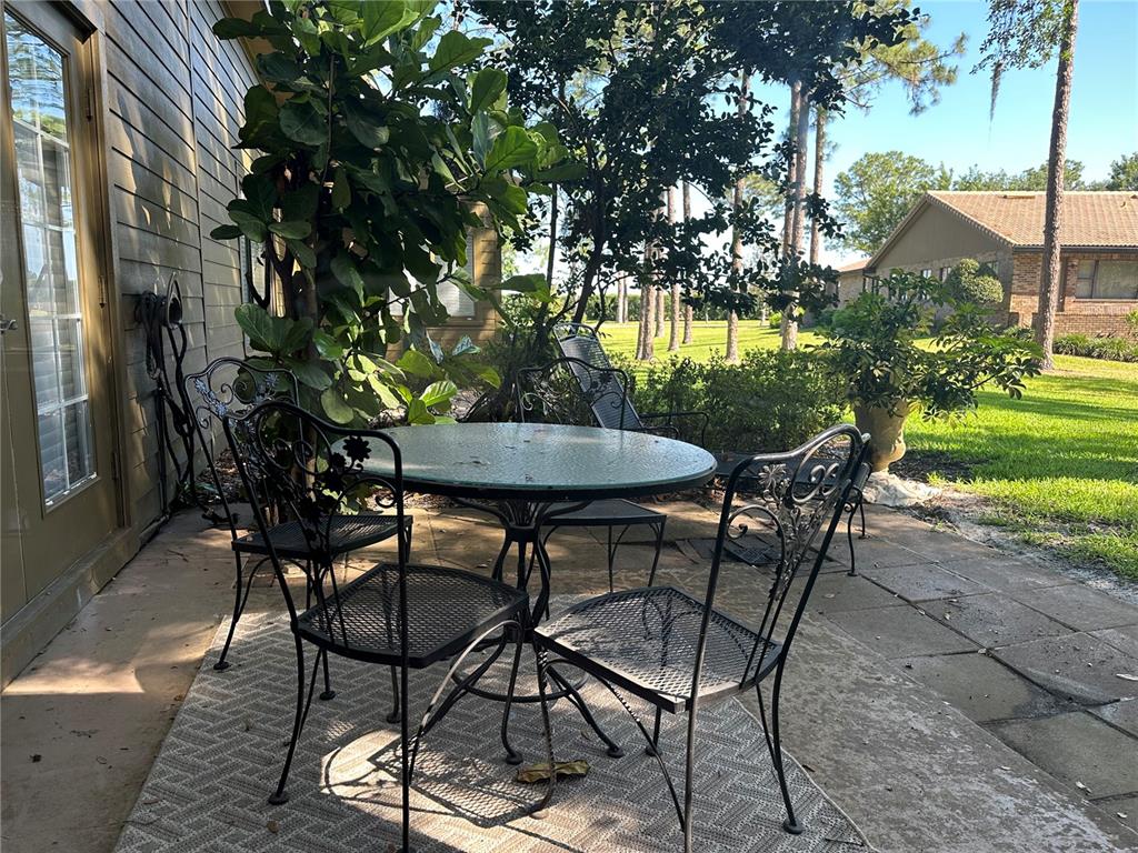 104 Woden Way Winter Haven, FL 33884 - Photo 33 of 48 a backyard of a house with table and chairs