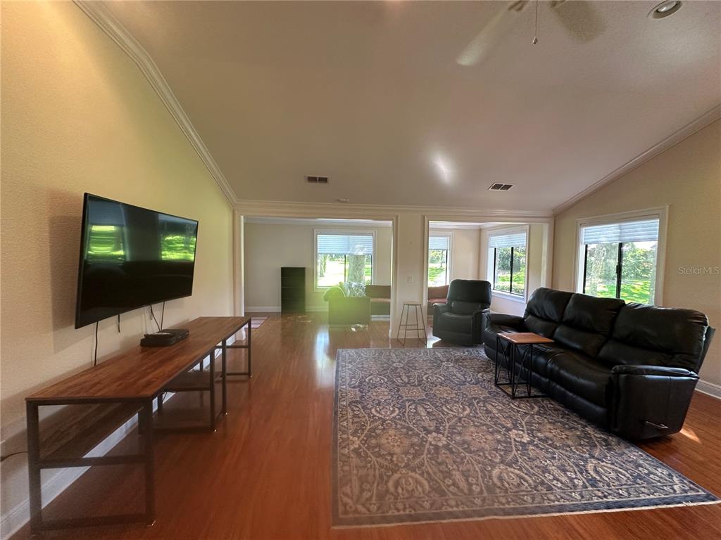 104 Woden Way Winter Haven, FL 33884 - Photo 7 of 48 a living room with furniture and a flat screen tv