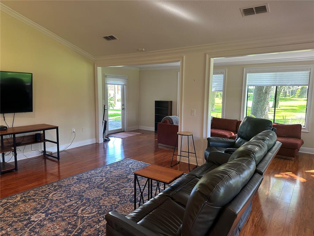 104 Woden Way Winter Haven, FL 33884 - Photo 9 of 48 a living room with furniture and a flat screen tv